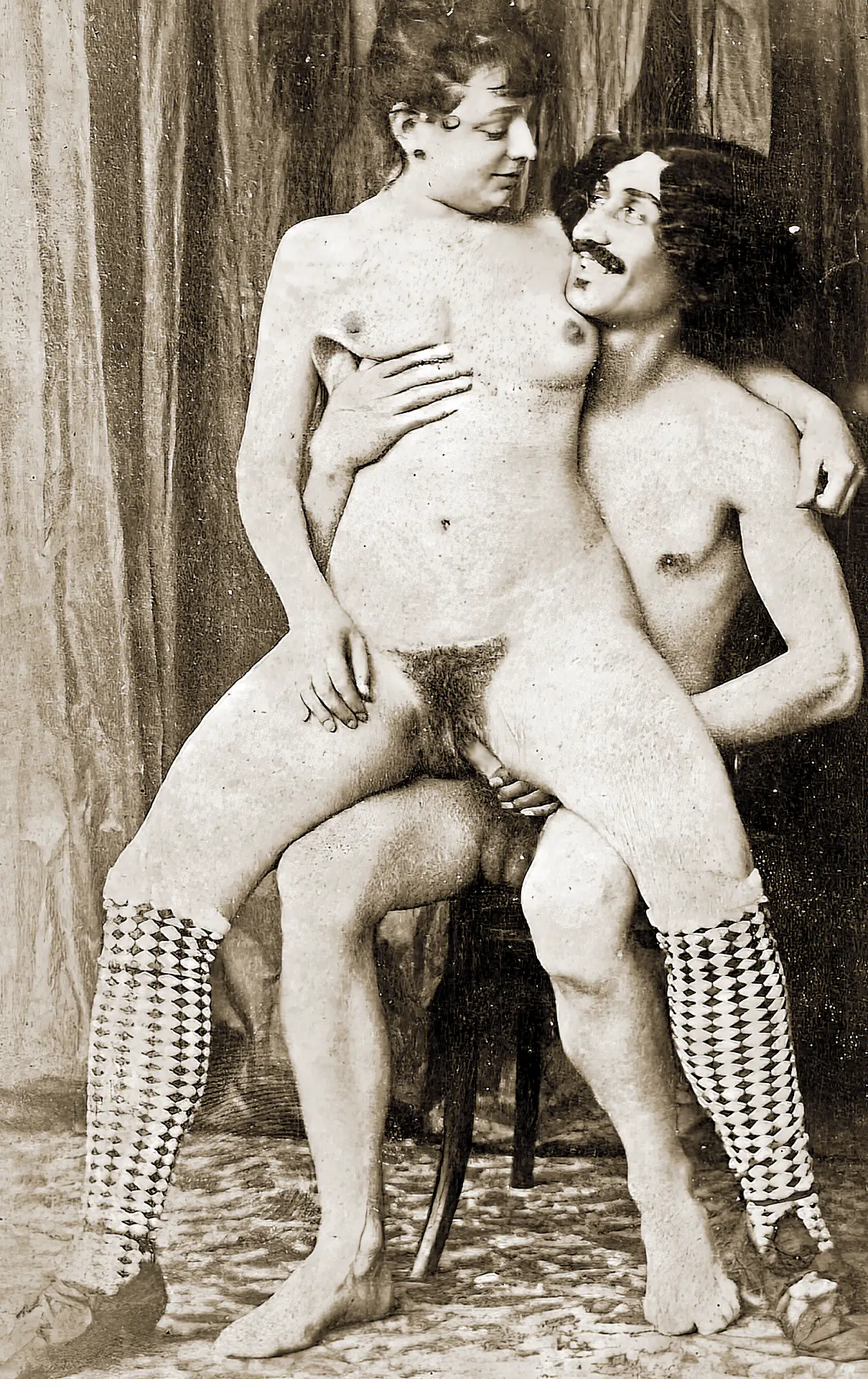Antique porn photos with nude woman with hairy pussy riding on a mustached man's cock while he's sitting on a chair