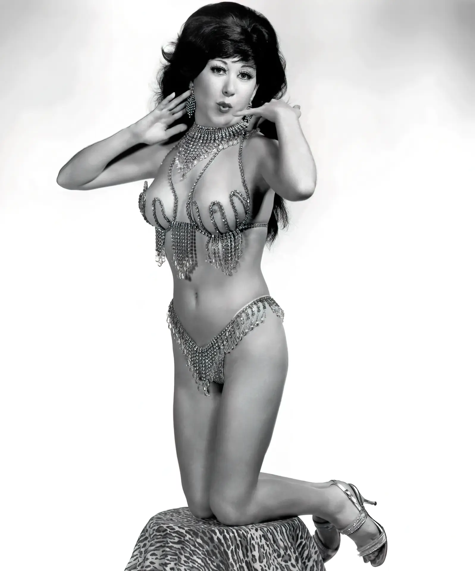 Brunette in a vintage burlesque bikini with her boobs peeking out