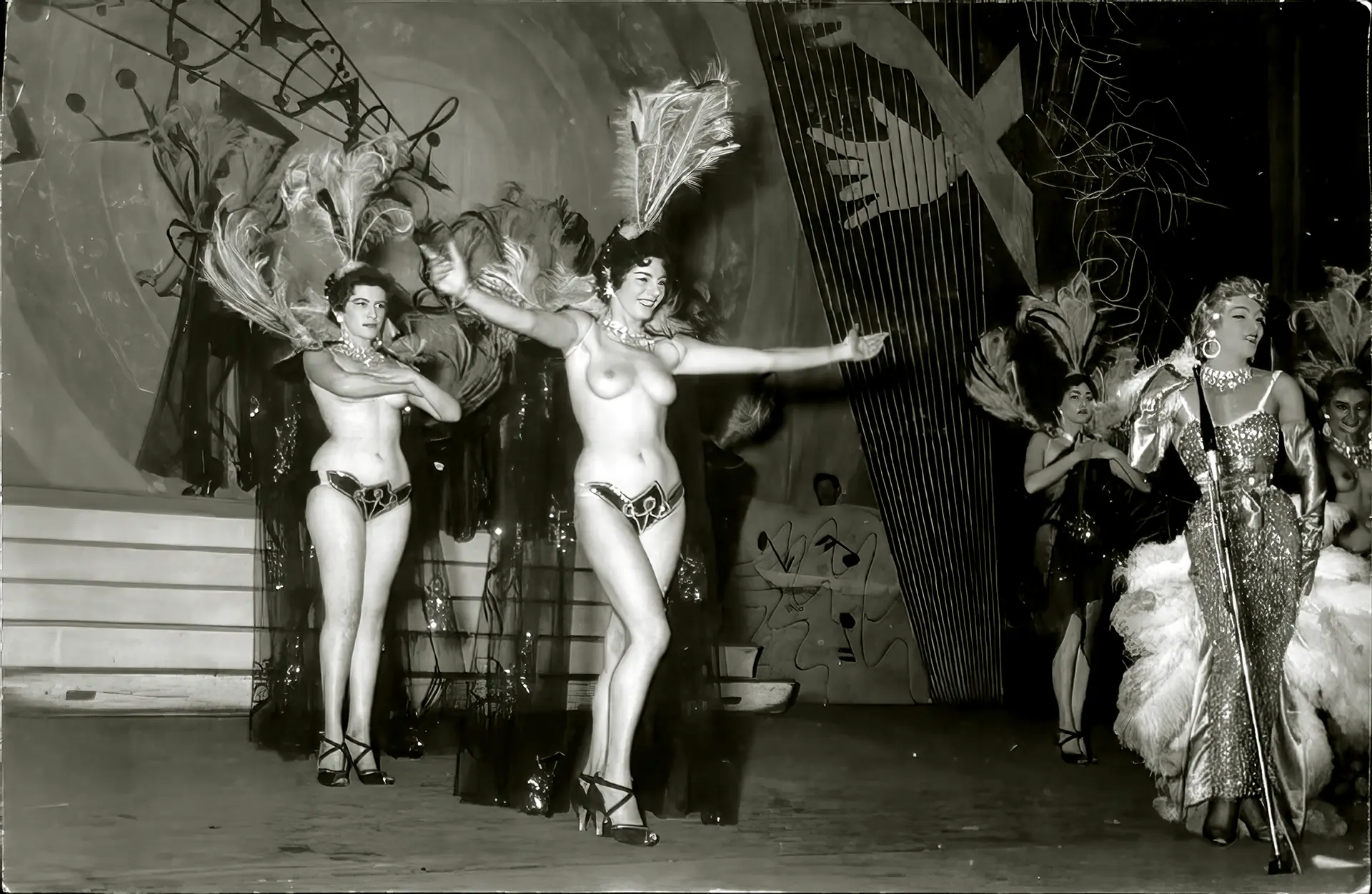 Topless vintage burlesque babes dance while a blonde sings