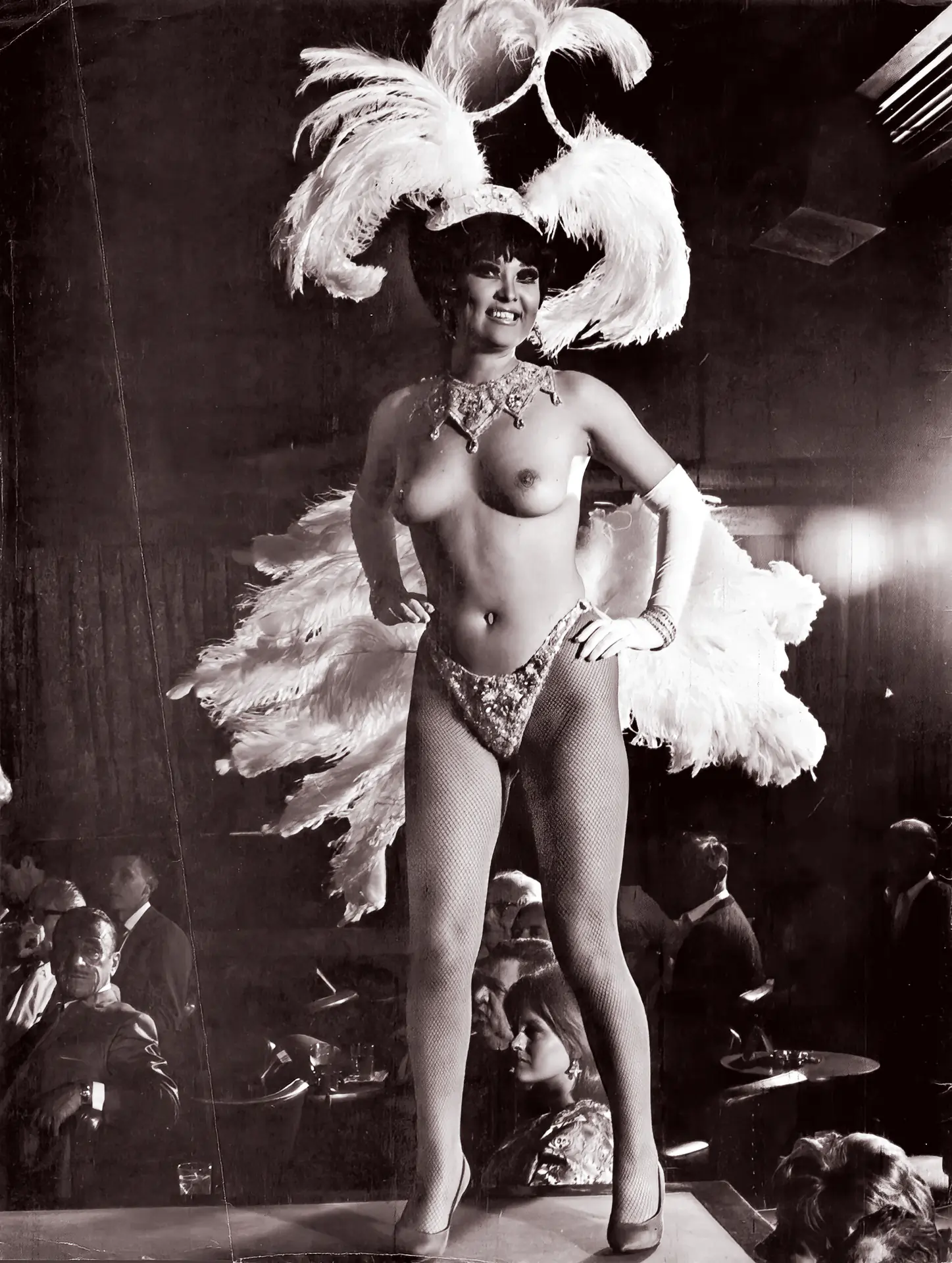 Topless vintage woman shows off her curves in a burlesque costume