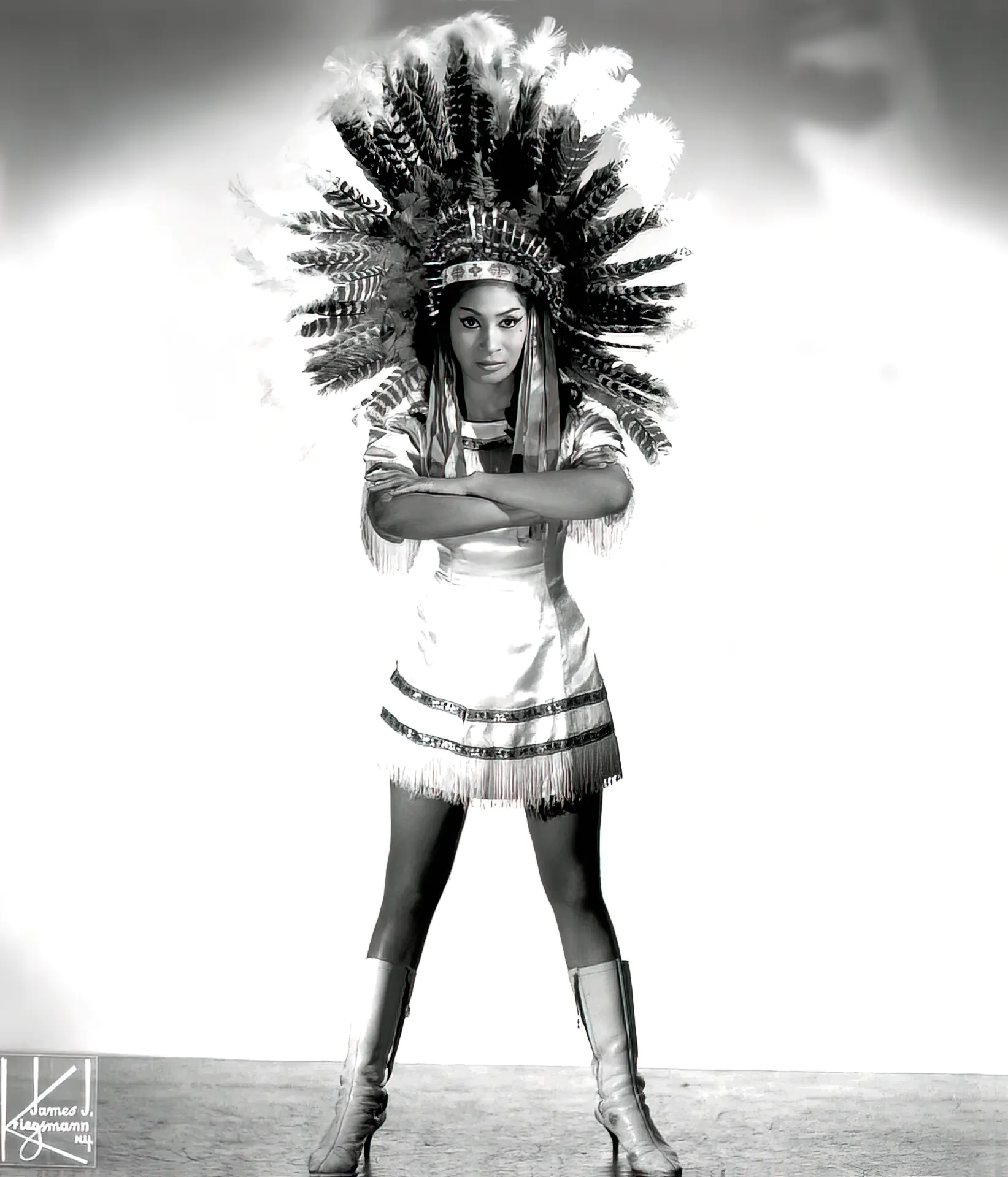 Sexy vintage babe poses with an Indian war bonnet