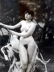 Vintage girl giving a dramatic look while posing naked with her dog retro