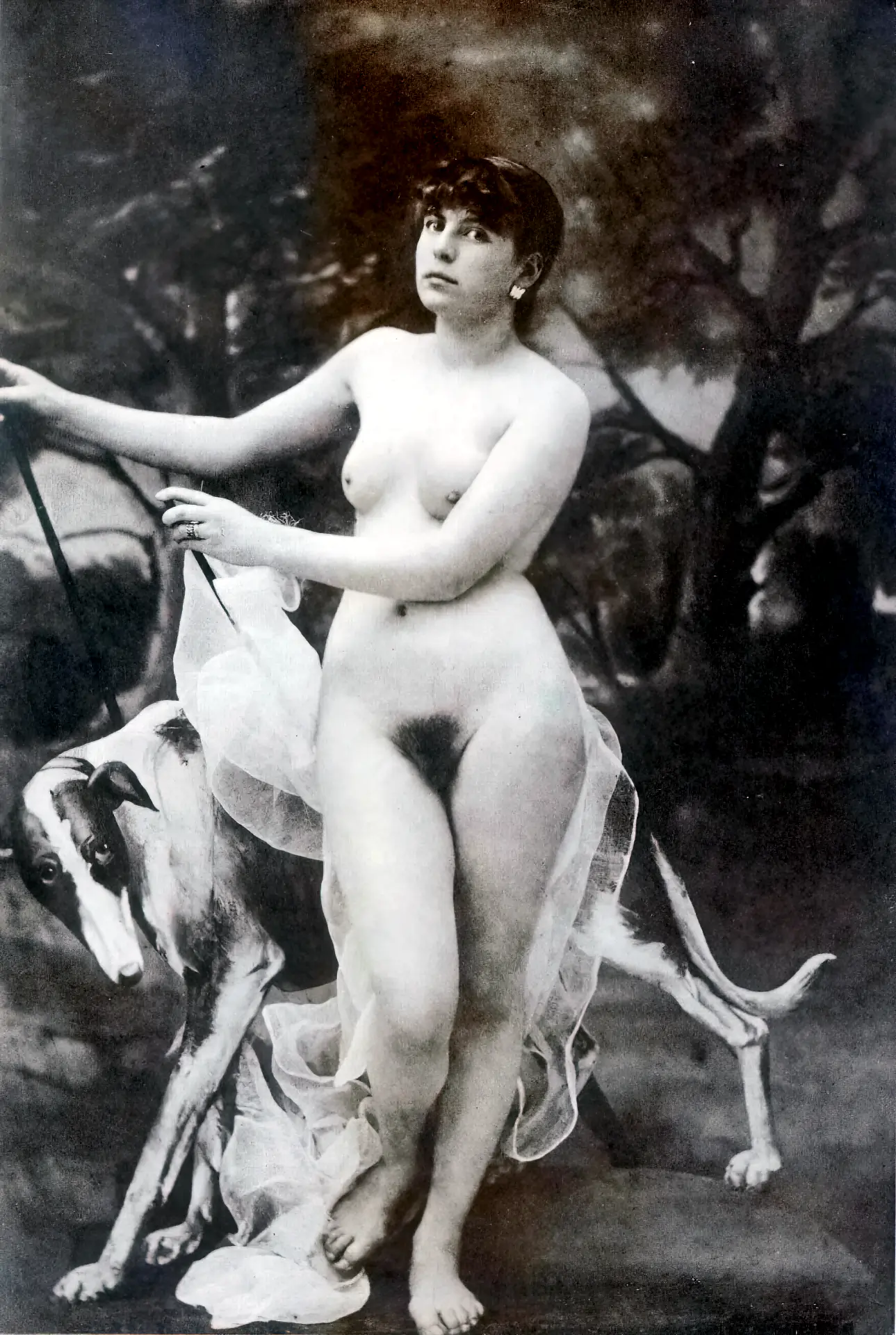 Vintage girl gives a dramatic look while posing naked with her dog