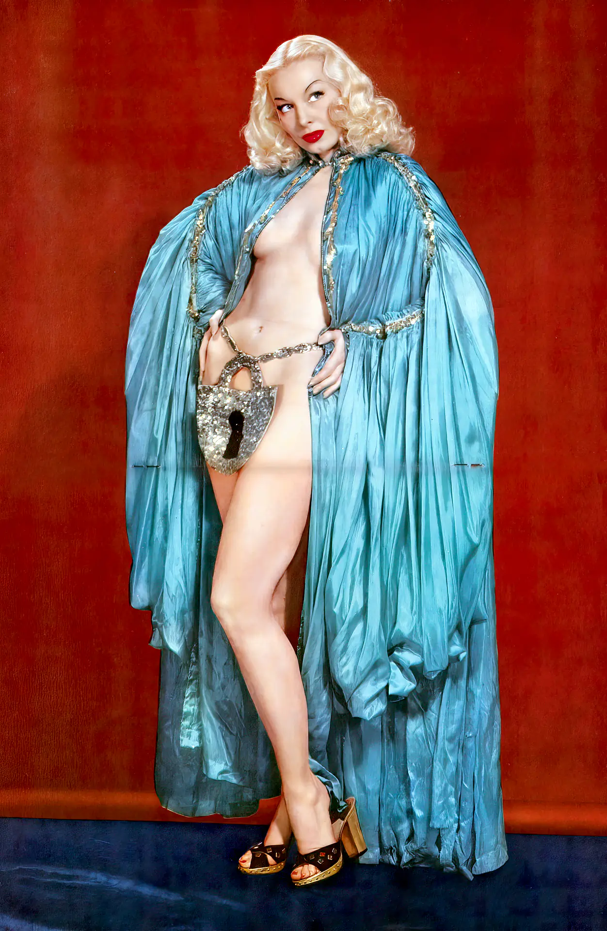 Lili St. Cyr wearing an extravagant robe that covers her body